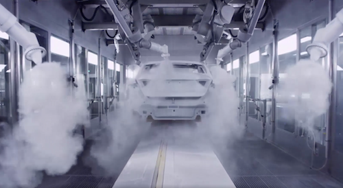 robots spraying paint inside paint booth by Encore Automation